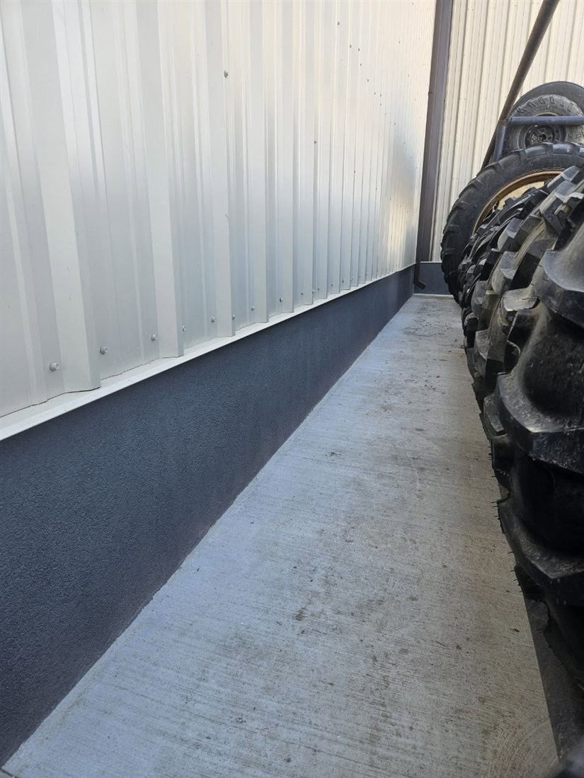 Grey parged foundation running the length of a home