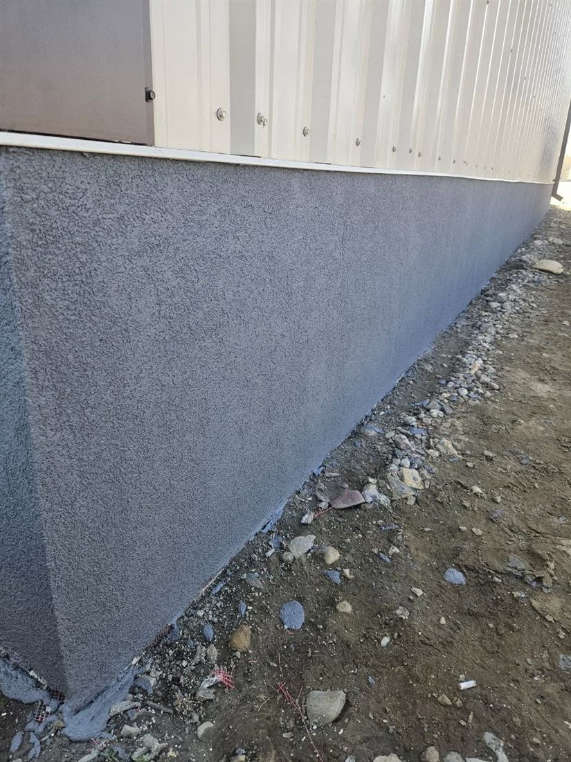 Long parged foundation wall with a crisp finish line